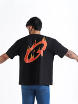 Person wearing a black t-shirt with a colorful logo on the back